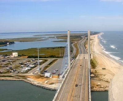 An aerial shot of the beach and bay from above the Indian River Inlet bridge.