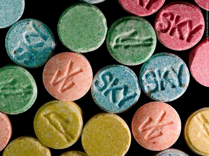 Troopers say they found approximately 450 MDMA/ecstasy tablets in Sutton's trunk.