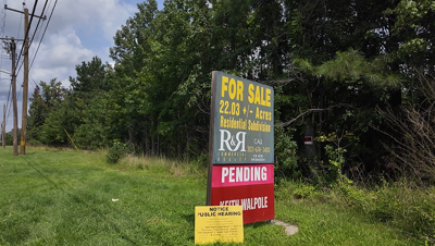 A photo of a pending sale sign on North Bedford Street land, currently underdeveloped. 