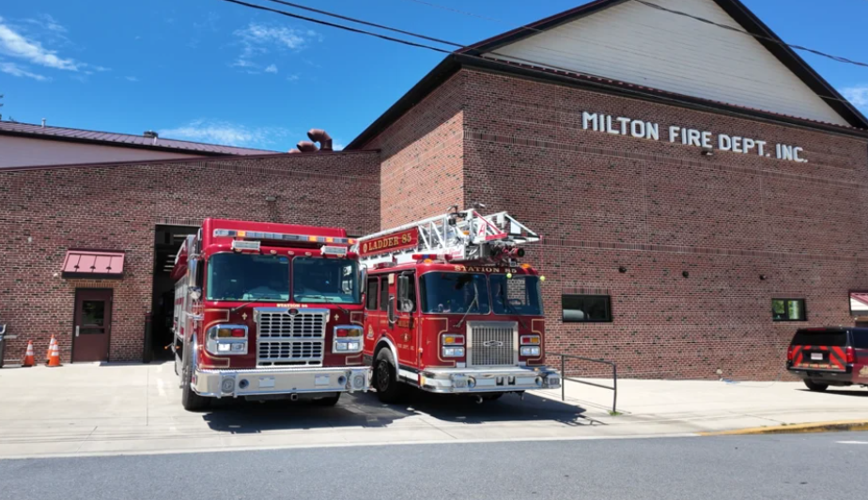 Two fire engine vehicles parked at the side of the Milton Fire Department's building on the corner of Front St. and Chestnut St.
