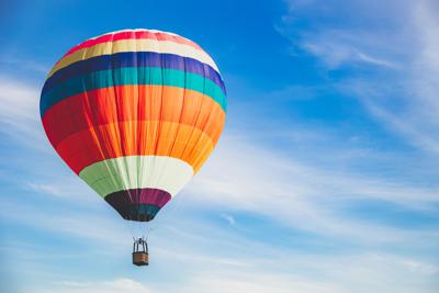 Colorful balloon flying on a summer sky.