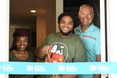 The Jeffcoat family cutting the ribbon for their home. 