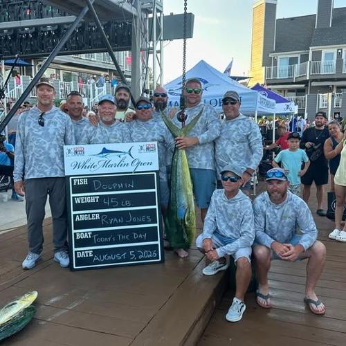 A group of men standing at the scales with their 45-pound dolphin.