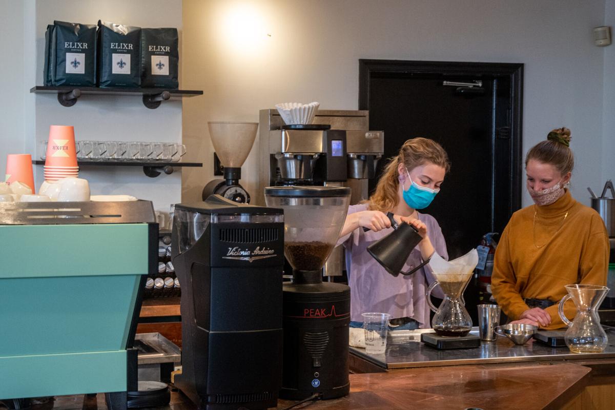 Annie Vidunas makes pour over drink at Elixr Coffee Roasters while Lucy Mylin observes