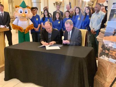 Gov. Jared Polis signs a memorandum of understanding with the U.S. Department of Agriculture