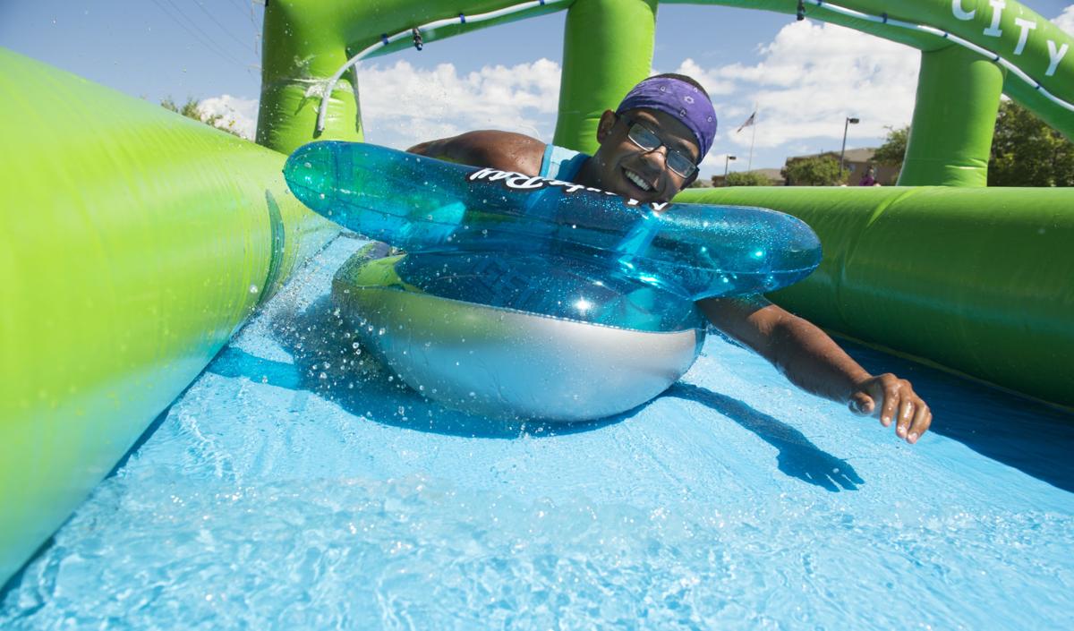 Colorado Springs resident splash their way along giant water slide