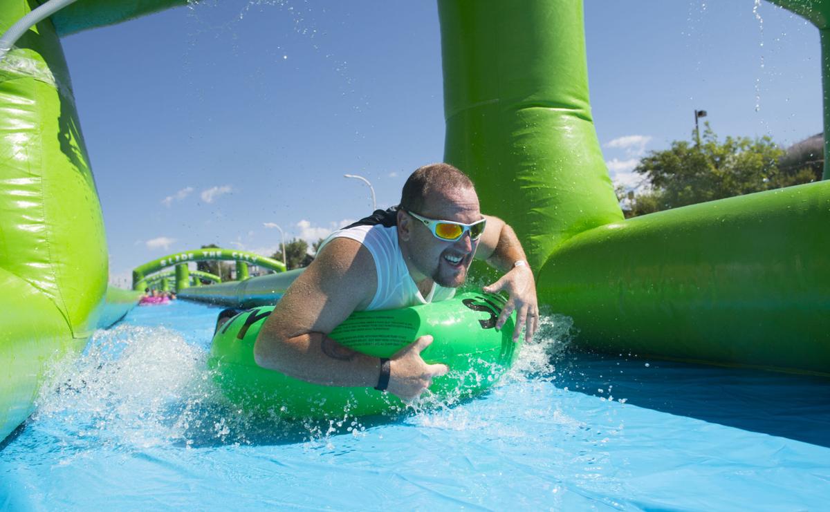 Colorado Springs resident splash their way along giant water slide