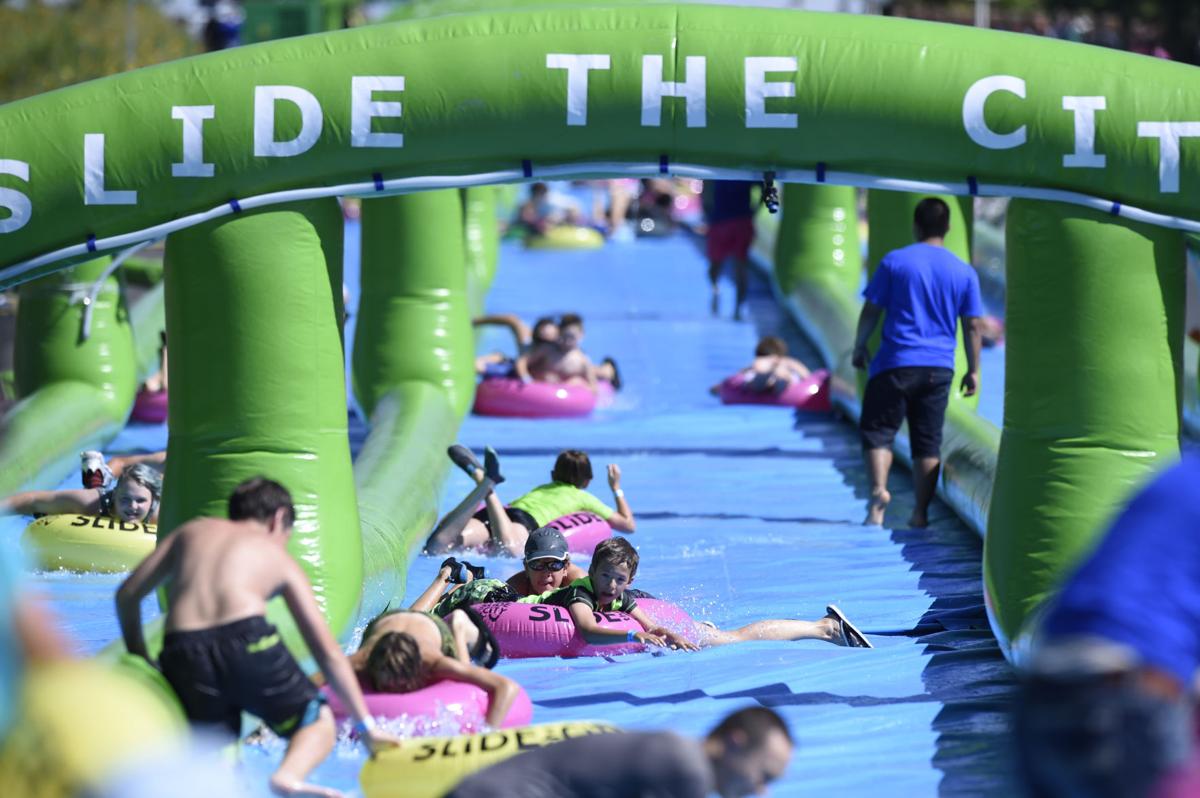 Colorado Springs resident splash their way along giant water slide