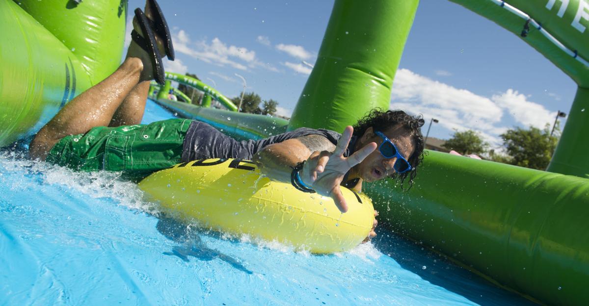Colorado Springs resident splash their way along giant water slide