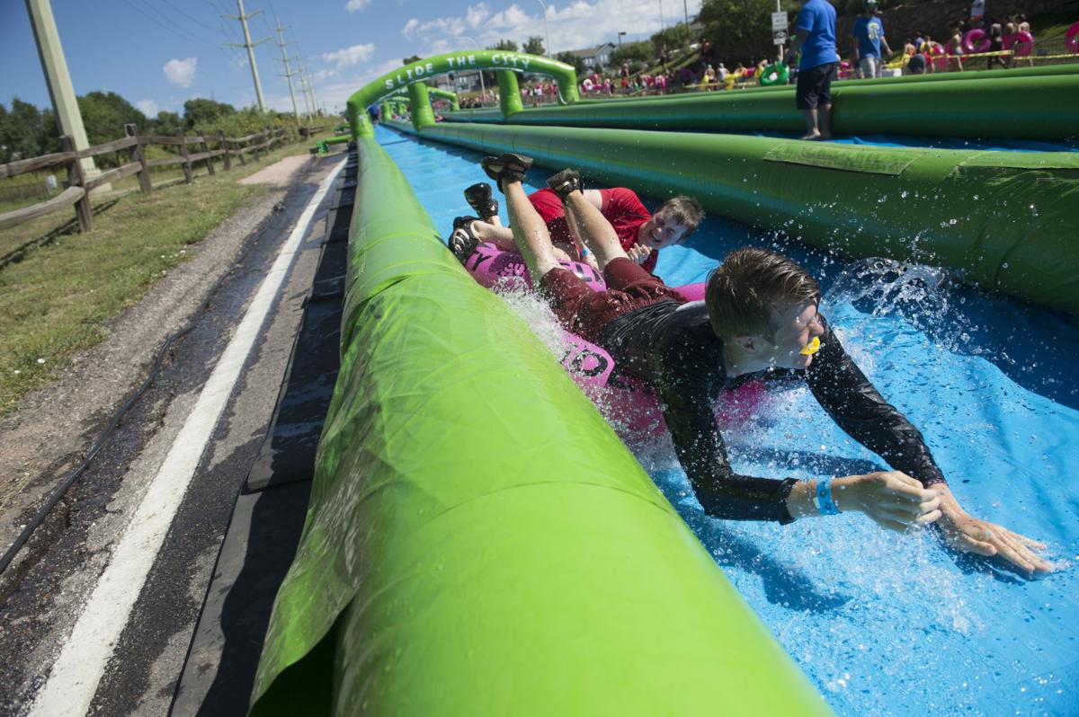Colorado Springs resident splash their way along giant water slide