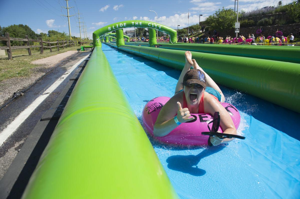 Colorado Springs resident splash their way along giant water slide