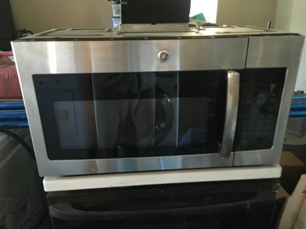 GE over the stove stainless microwave $150 30 day warranty ph 541 298 2687 image 1
