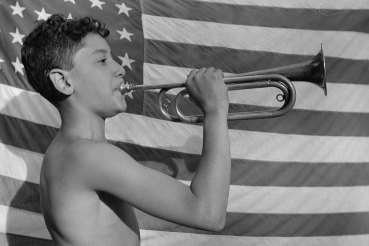 A camper blows a bugle at Camp Nathan Hale in upstate New York in 1943.
