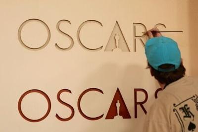 Workers are putting the finishing touches on the red carpet for the Oscars gala in Hollywood