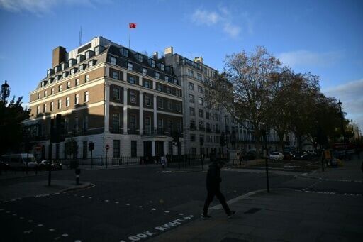 A flag flies atop a pole on the roof of the Embassy of the People's Republic of China in the United Kingdom, on Portland Place in London