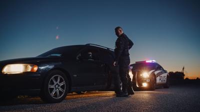 Portrait,Of,Middle,Aged,Caucasian,Cop,Approaching,A,Pulled,Over
