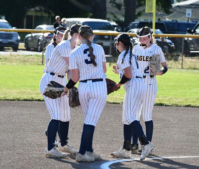 The HRV softball team gathers before an inning earlier this year.