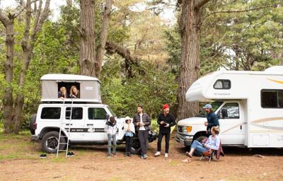 Families with their RVs set up enjoy a camp site