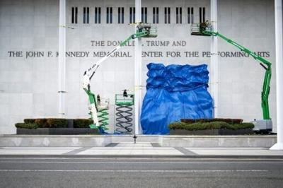 A blue tarp is dropped after the renaming of The John F. Kennedy Memorial Center for the Performing Arts in honor of US President Donald Trump