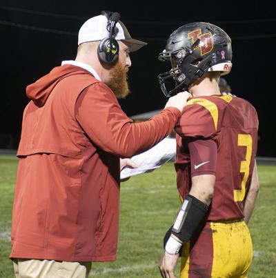 The Dalles head coach Nate Timmons gives the play call to quarterback Logan Mitchell (3) against La Grande    Zach Thummel photo