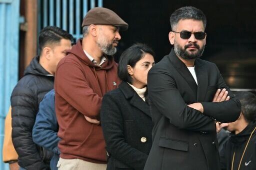 Prime ministerial hopeful Balendra Sha, dressed in a dark suit and sunglasses, lined to vote in Kathmandu