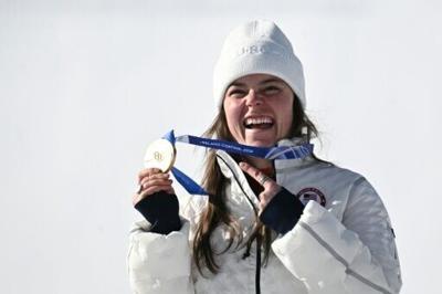 Breezy Johnson shows off her Olympic gold medal from the women's downhill alpine skiing - but it later broke
