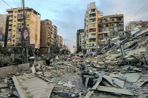 The rubble of a destroyed building at the site of an overnight Israeli airstrike in Beirut's southern suburbs on March 28, 2026