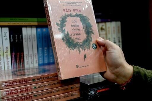 A man holds the book "The Sorrow of War" in a bookstore in Hanoi