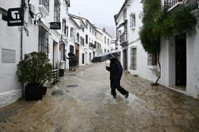 A man crosses a flooded street in Grazalema, southern Spain, on February 5 during Storm Leonardo
