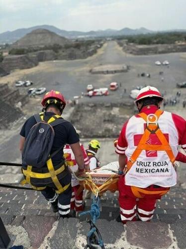 This handout picture released by the Mexican Red Cross shows the removal of the body of a Canadian woman who was shot dead at Teotihuacan by a man who later killed himself