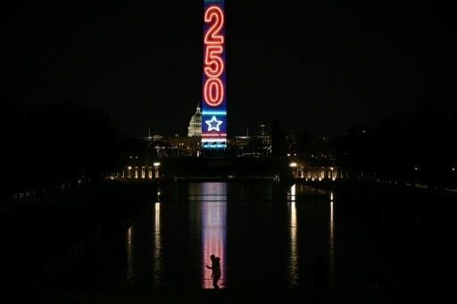 The Washington Monument is illuminated with a projection of US President Donald Trump's "Freedom 250" initiative during the New Year's Eve show at the National Mall in Washington, DC on December 31, 2025