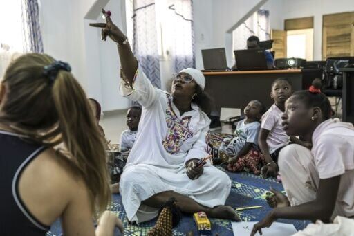 Psychotherapist Katy Faye points to a screen during a support session with children whose migrating parents have died at sea