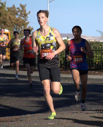 Tyson Long from The Dalles cross country runs past spectators at the district meet earlier this year  Zach Thummel photo