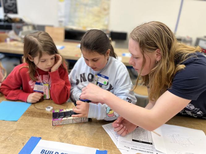 A member of the Hood River Valley High School Solar Car Club helps students build and race a solar car.