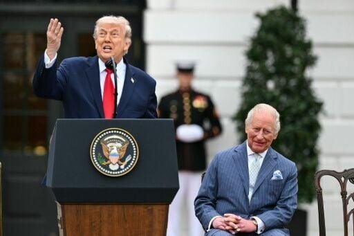 US President Donald Trump speaks as Britain's King Charles III looks on during an arrival ceremony at the White House