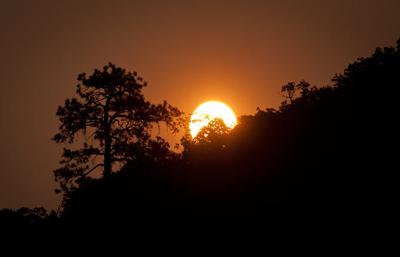 The Latest: 6 hikers rescued after 140 trapped by wildfires