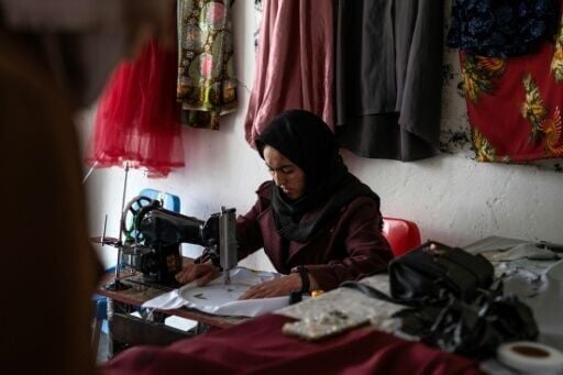 Rahima Alavi embroiders a scarf at her boutique in Bamiyan