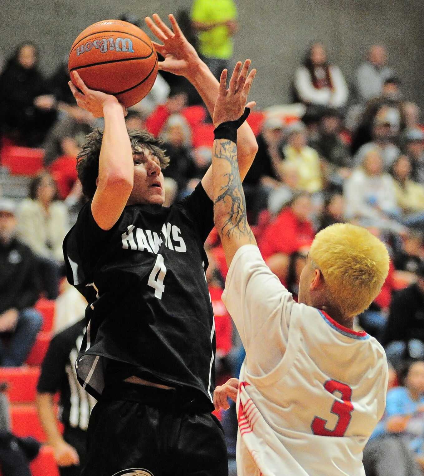 Riverhawk senior, Hudson Case (4) attempts a short range jumper against the Seaside defense in late first half action on Friday night in Seaside.  Rob Hilson photo