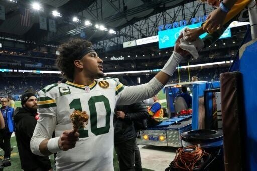 Green Bay Packers quarterback Jordan Love shakes hands with fans after the team's NFL Thanksgiving holiday win over the Detroit Lions