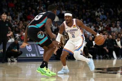 Shai Gilgeous-Alexander of the Oklahoma City Thunder drives against Cedric Coward in the Thunder's NBA victory over the Memphis Grizzlies