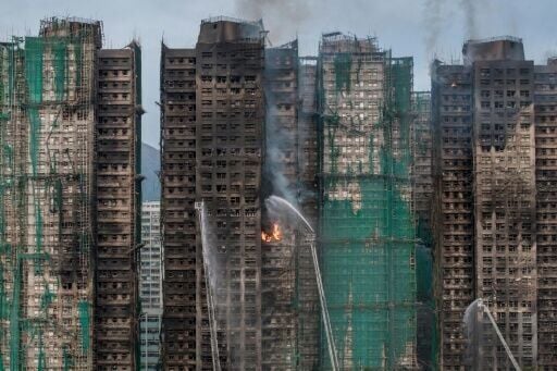 Smoke rises from apartments after a major fire swept through several blocks at the Wang Fuk Court residential estate