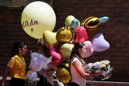 People carry balloons as they arrive for the funeral of 10-year-old Matilda, who was killed in the December 14 Bondi Beach shooting attack.