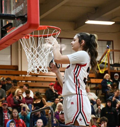 Big Sky girls player of the year Hailey Pechanec (32) cuts down the net after the Big Sky championship on Feb. 21.
