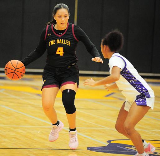 The Dalles’ Jackie Begay (4) challenges Astoria’s Essence Harris at Astoria High School last Saturday.
