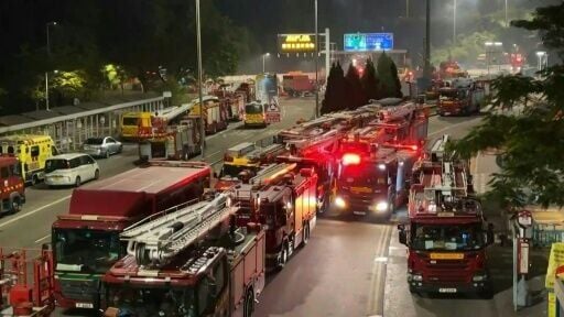 Hong Kong housing blocks still burning as firefighters work to control flames