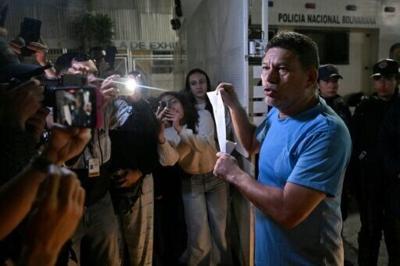 Franklin Parra shows his release order after leaving the Bolivarian National Police Zone 7 prison in Caracas