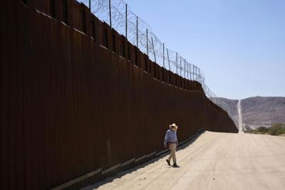 A volunteer walks along the U.S.-Mexico border near Jacumba Hot Springs, Calif., on June 5, 2025.