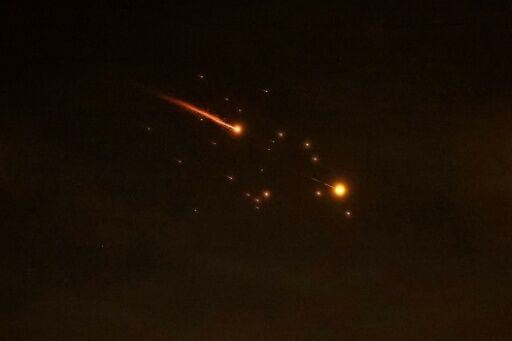 Rocket trails are seen in the sky amid a fresh barrage of Iranian missile attacks above the Israeli coastal city of Netanya on March 23, 2026