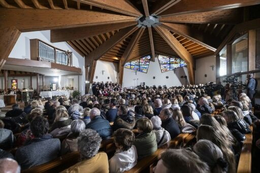 Attendees look on during a memorial mass at Crans-Montana's the catholic chapel of Saint-Christophe