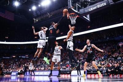 San Antonio's Victor Wembanyama blocks a shot by RJ Barrett in the Spurs' NBA victory over the Toronto Raptors